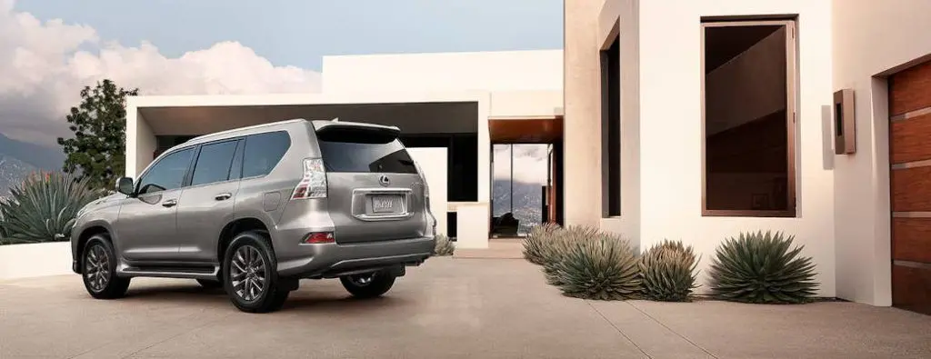A 2023 Lexus GX 460 in the driveway of a nice, southwestern style home.
