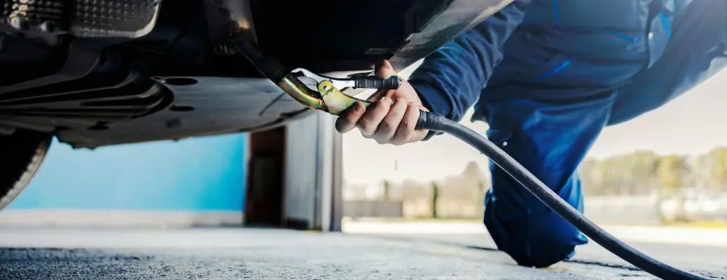 A mechanic performing an emissions test on a car.