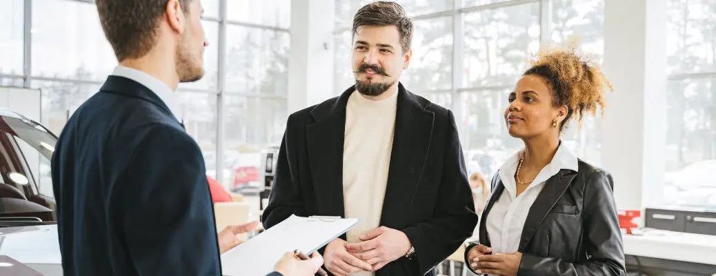 People looking at new cars.