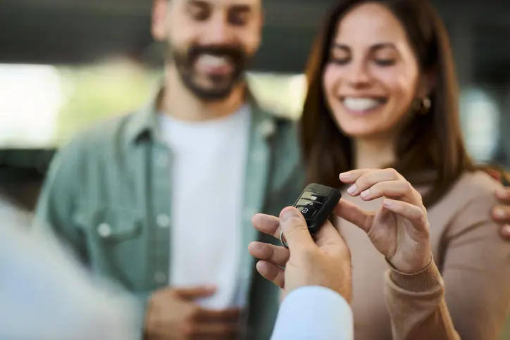 A couple receiving their new or used car