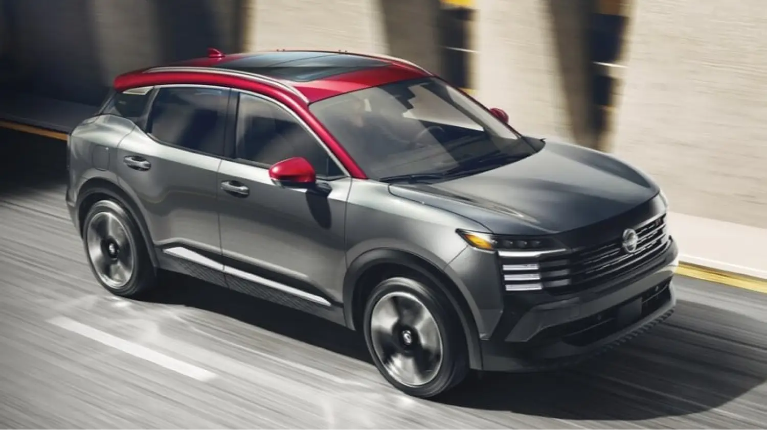 Nissan SUV driving on a city street with a two-tone gray and red exterior