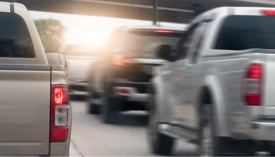 Pickup trucks driving on a road with motion blur.