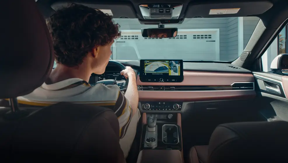 Driver using a Mitsubishi backup camera inside a vehicle at Bob Mills Mitsubishi in Myrtle Beach, SC.