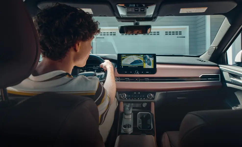 Driver using a Mitsubishi backup camera inside a vehicle at Bob Mills Mitsubishi in Myrtle Beach, SC.