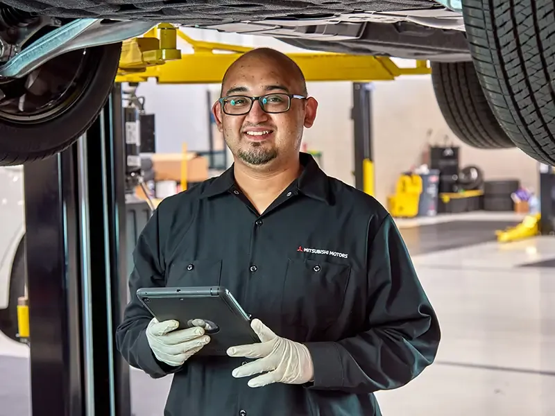 Mitsubishi service technician working on a vehicle at Bob Mills Mitsubishi.
