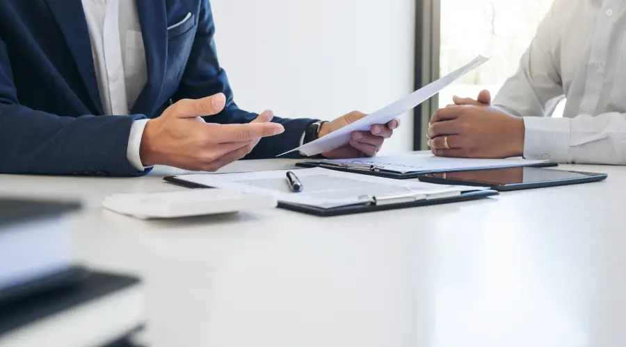 Two people discussing finance documents