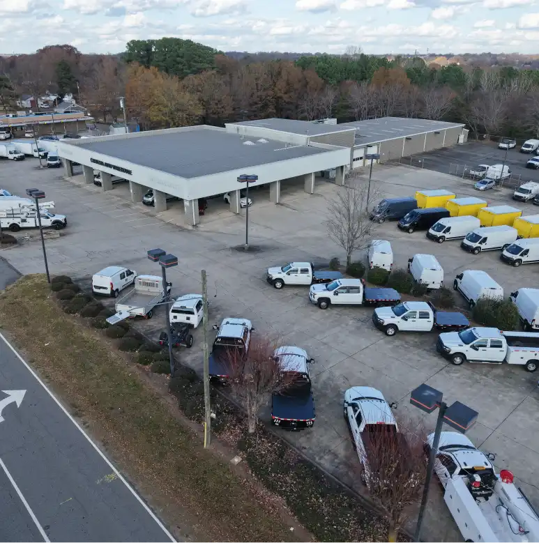 erial view of Carolina Auto Warehouse dealership with trucks, vans, and service building