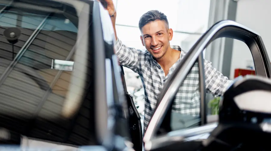 Man getting into a new car