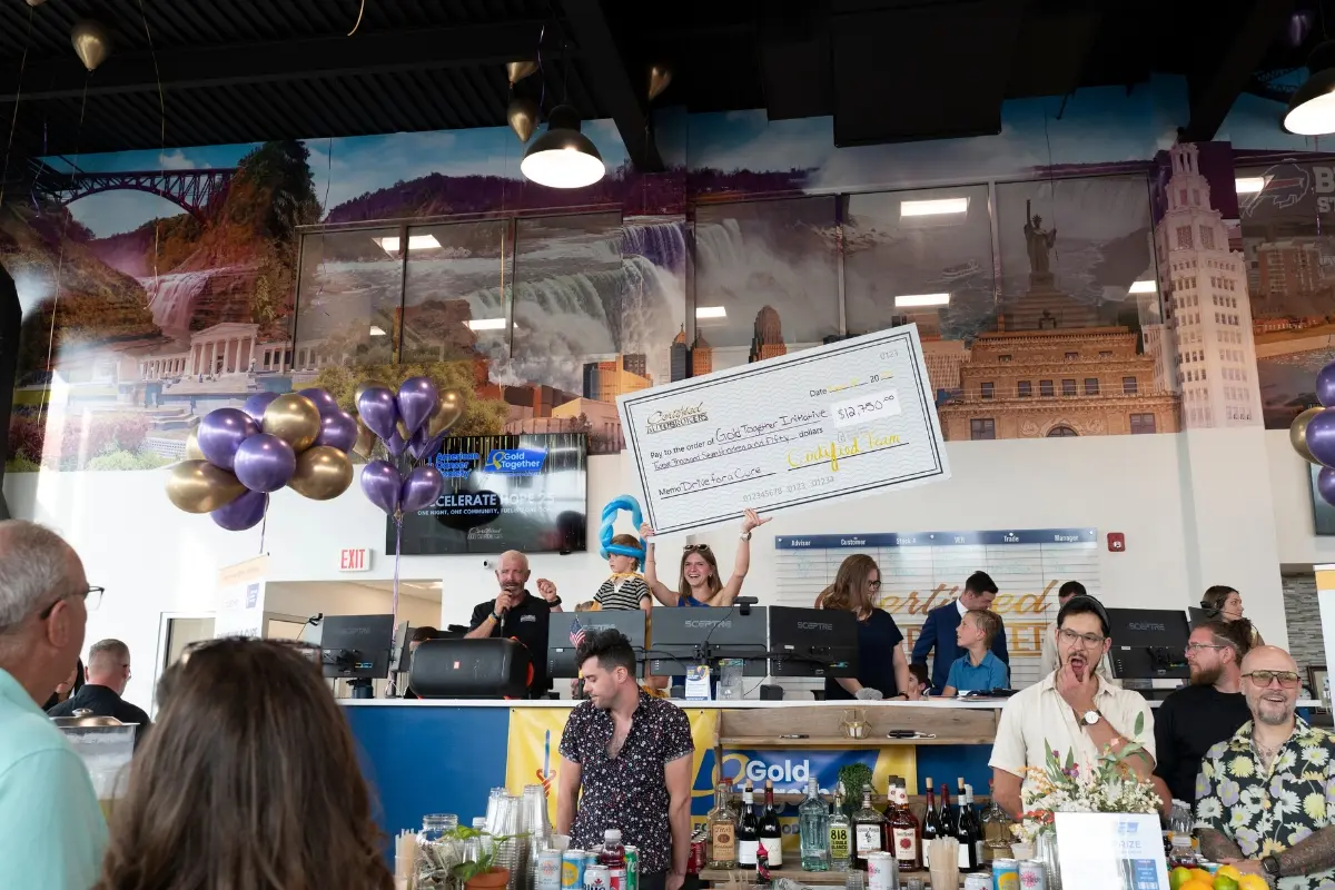 Certified Team presenting a 12750 dollar Drive for a Cure check to the Gold Together Initiative at Certified AutoBrokers in Grand Island NY