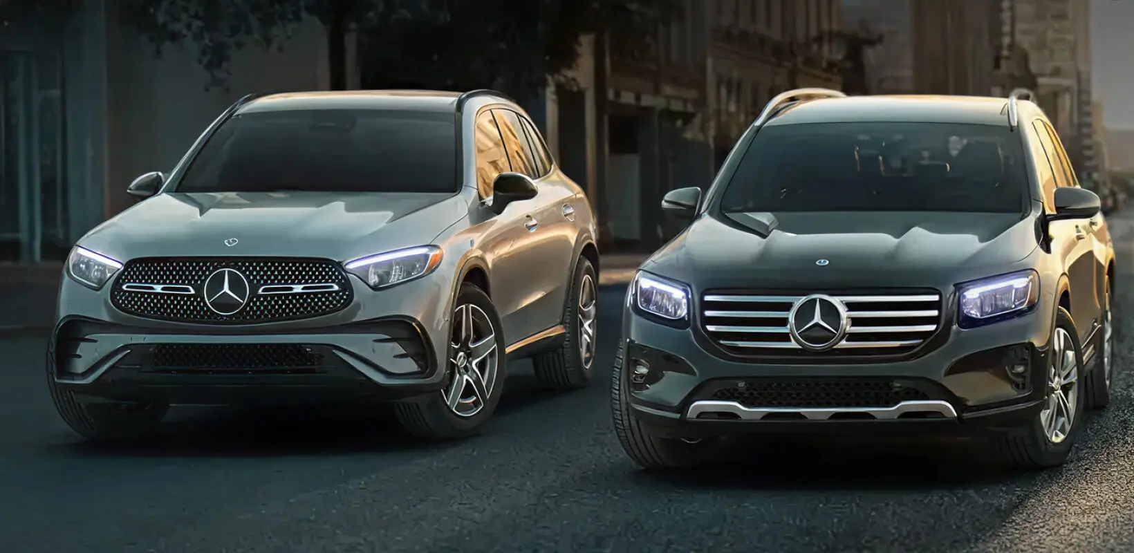Two Mercedes vehicles parked on a city street.
