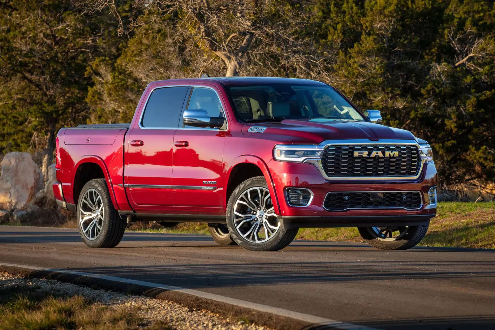 A red ram 1500 sitting in the road.