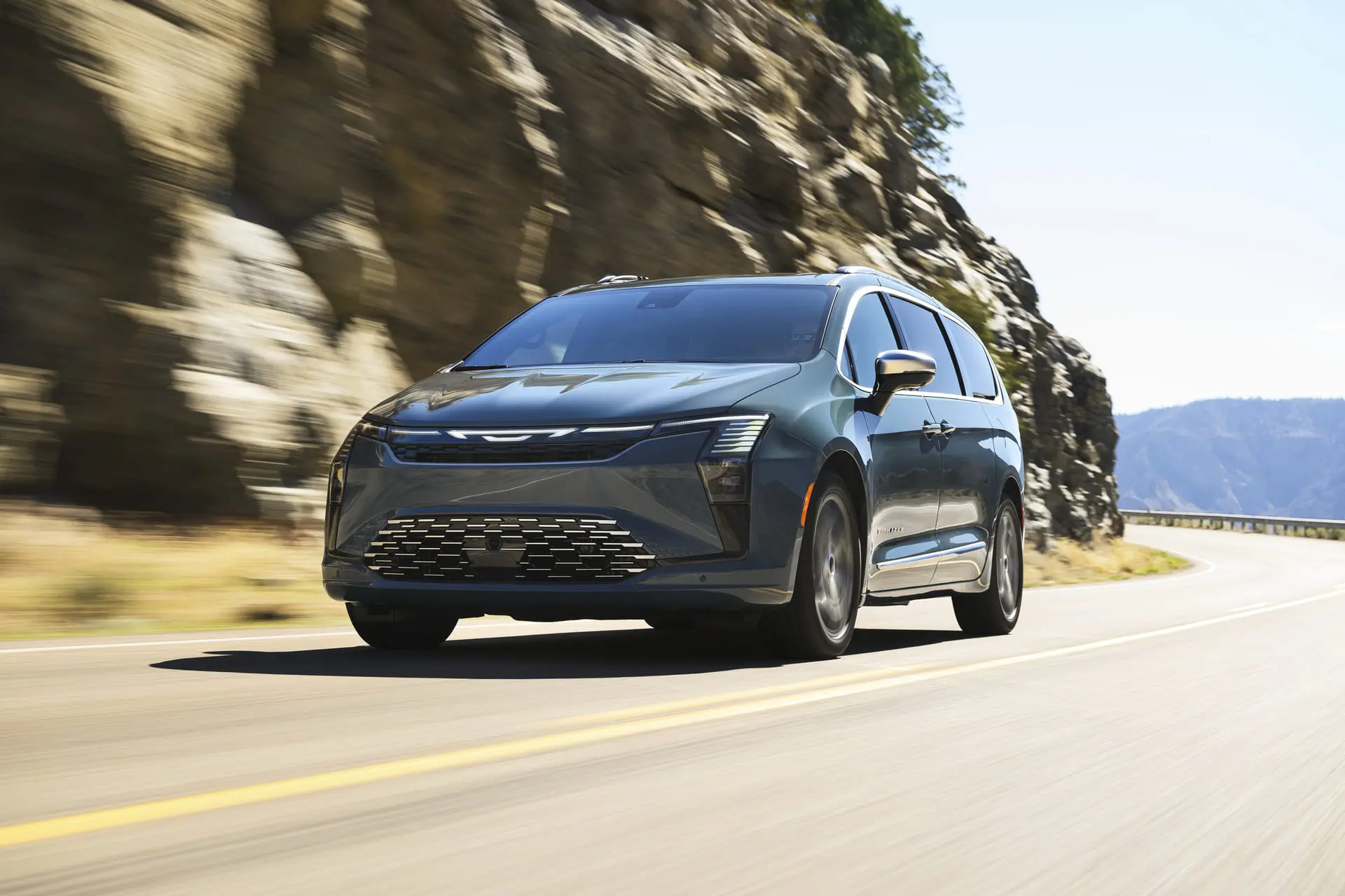 A chrysler pacifica driving on the road.