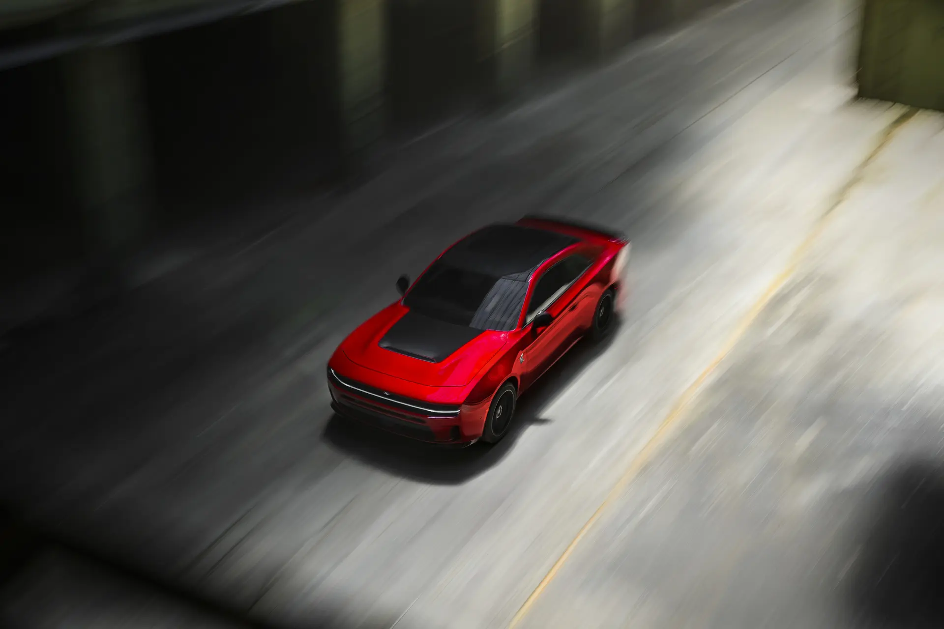 An Red car driving on the road.