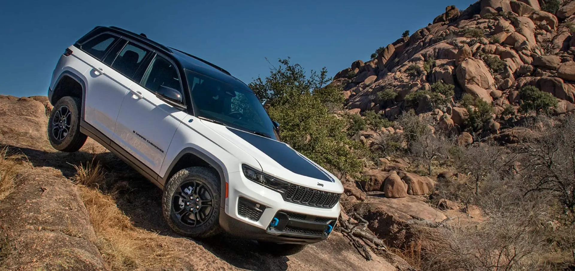 A white suv driving off-road.