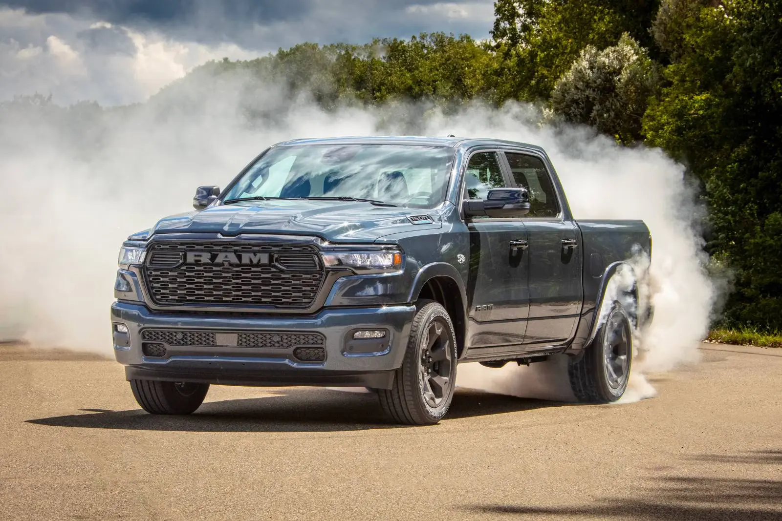 A gray truck driving on a road.