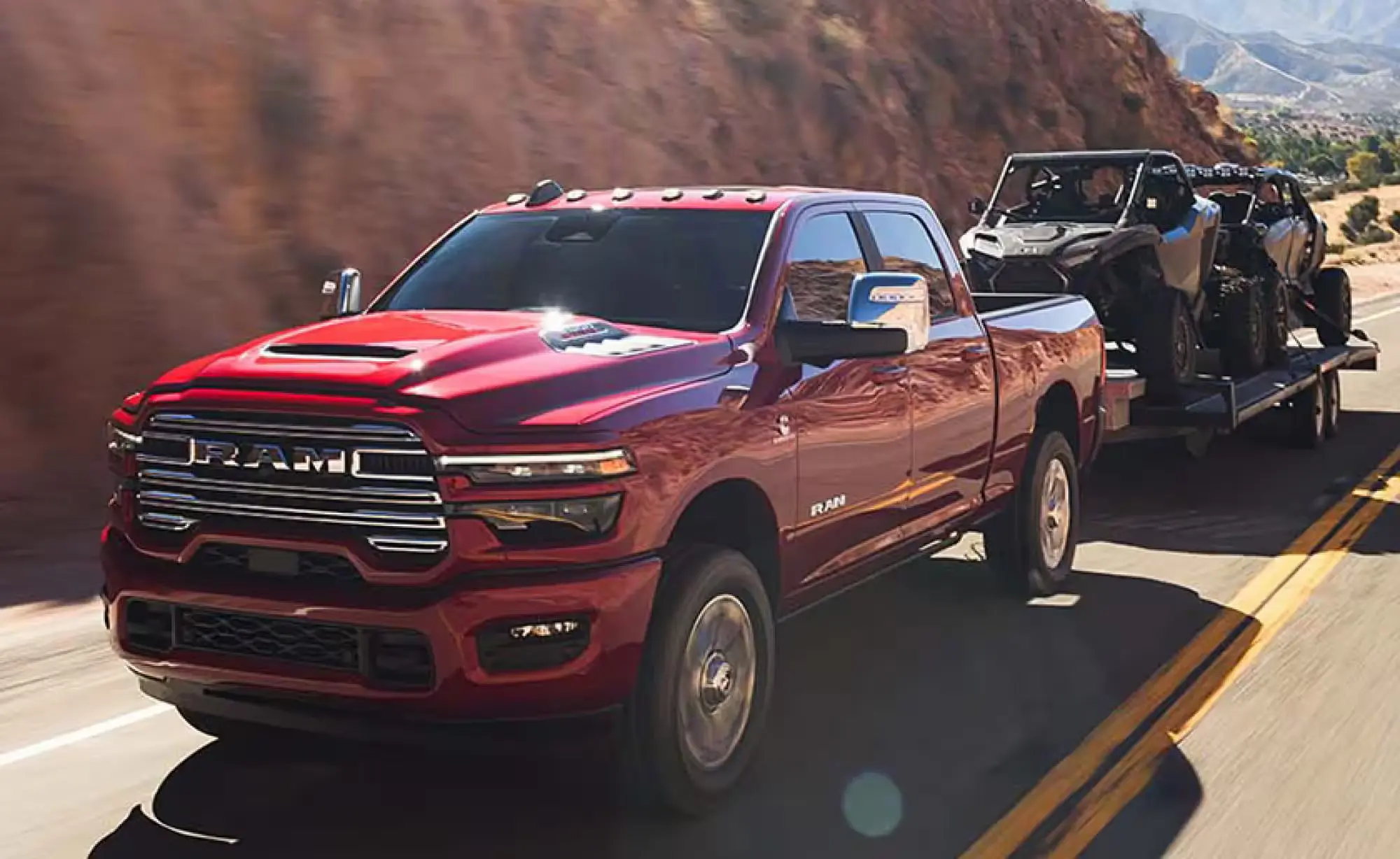 A red truck pulling a trailer on the road.