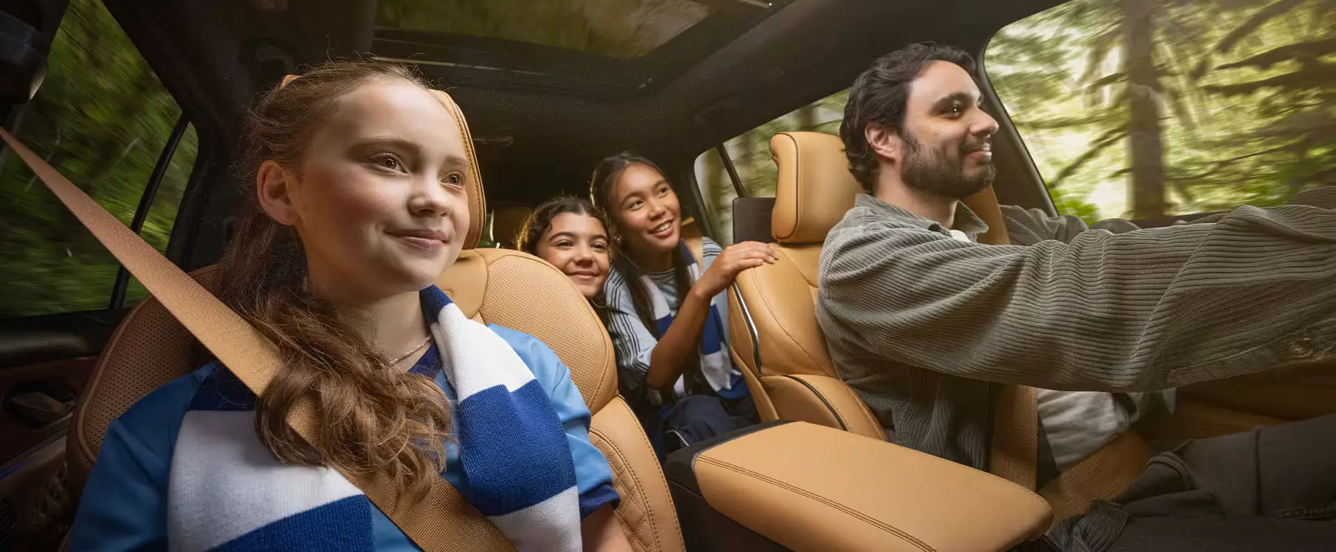 A family sitting inside the grand cherokee.