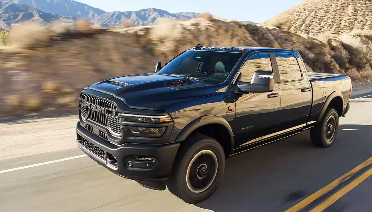 A black truck driving on the road.
