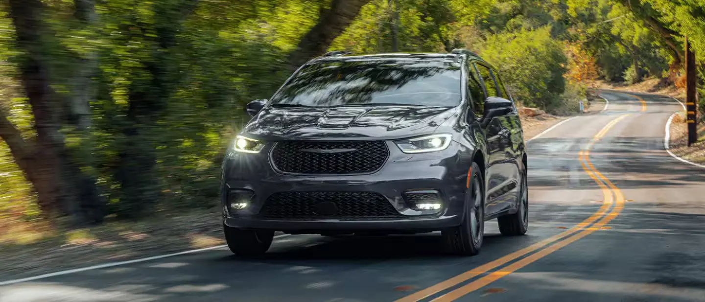 A gray van driving on the road.