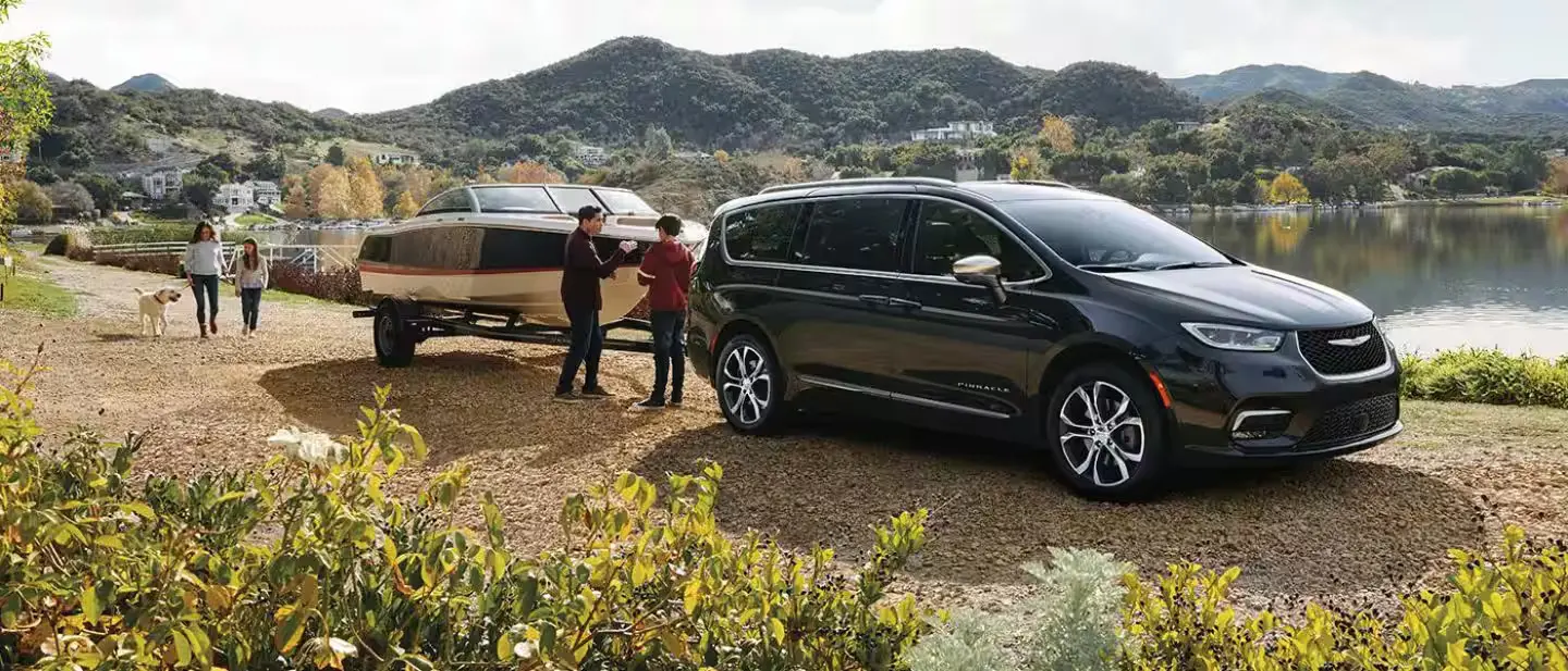 A pacifica pulling a boat.