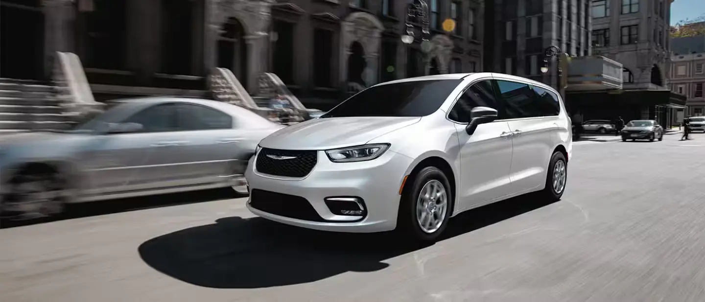 A white van driving on the road.