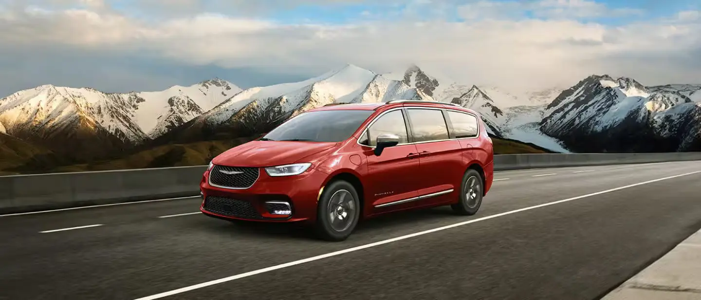 A red van driving on the road.