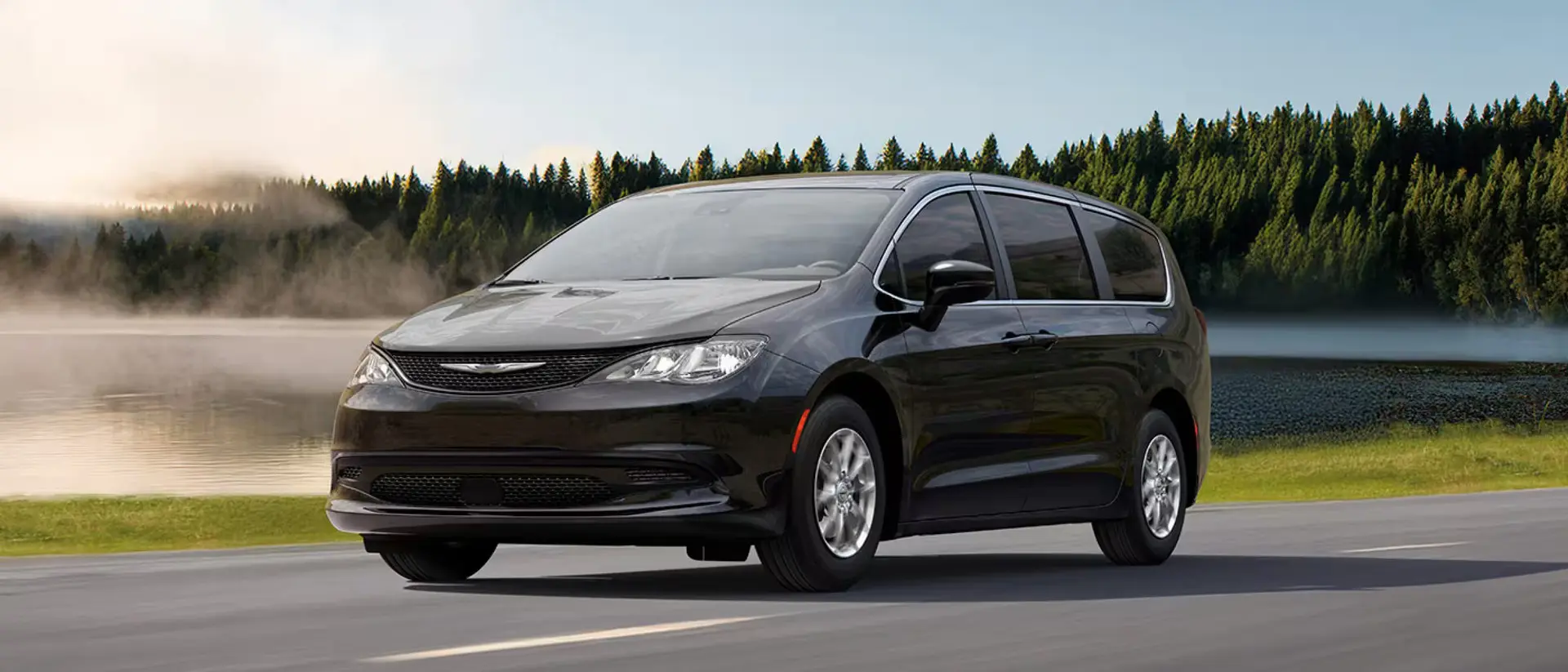 A gray van driving on the road.