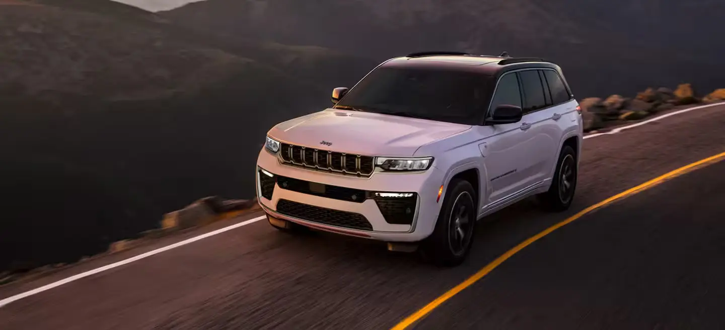 A white suv driving on the road.