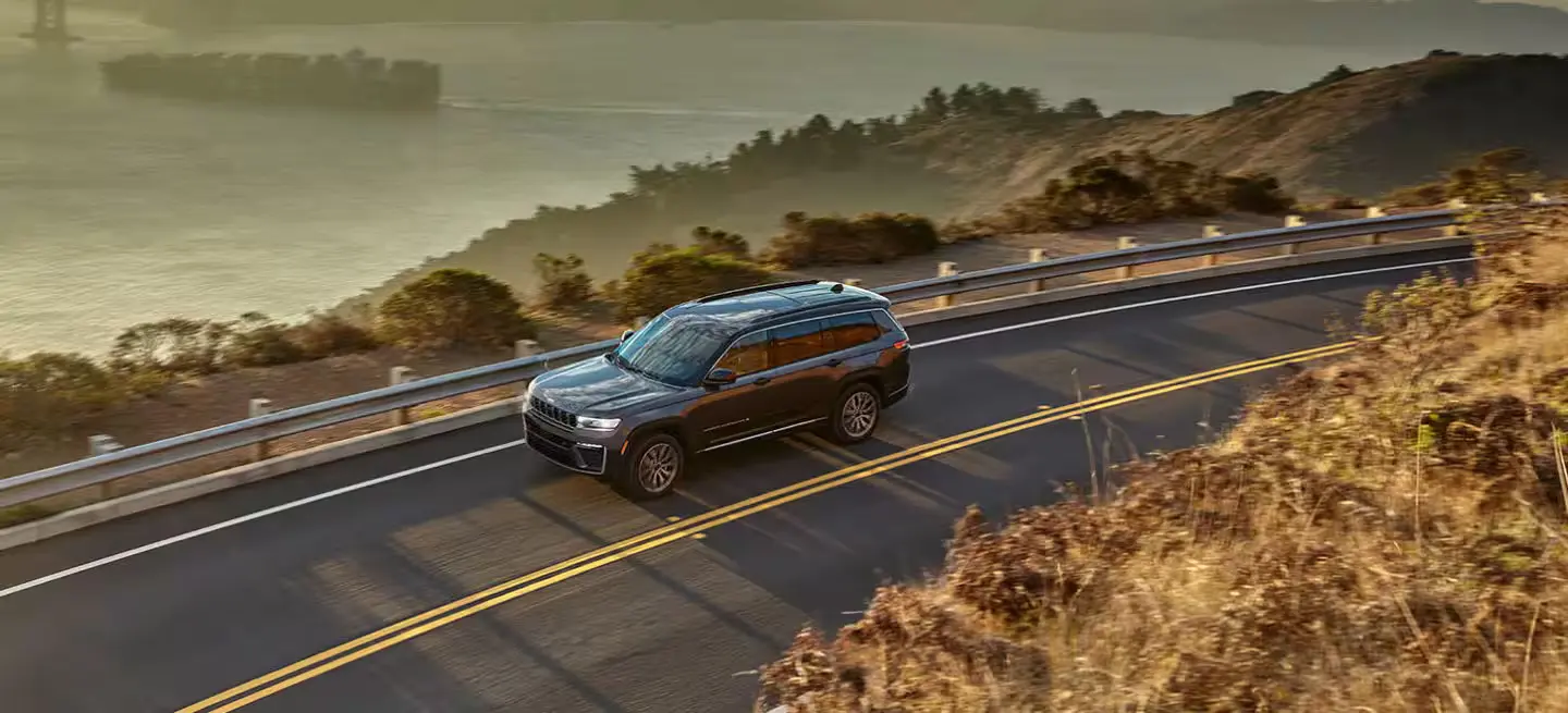A jeep grand cherokee driving on the road.