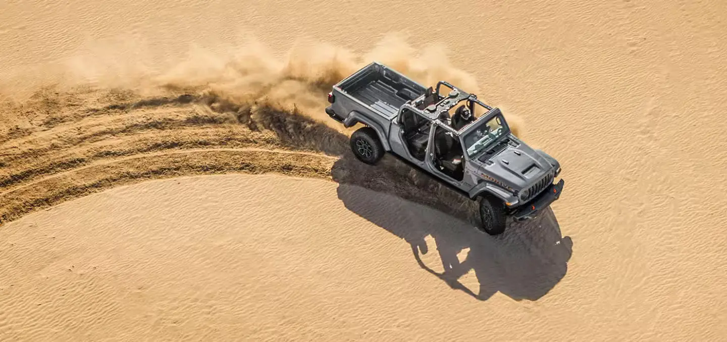 A jeep gladiator driving off-road.