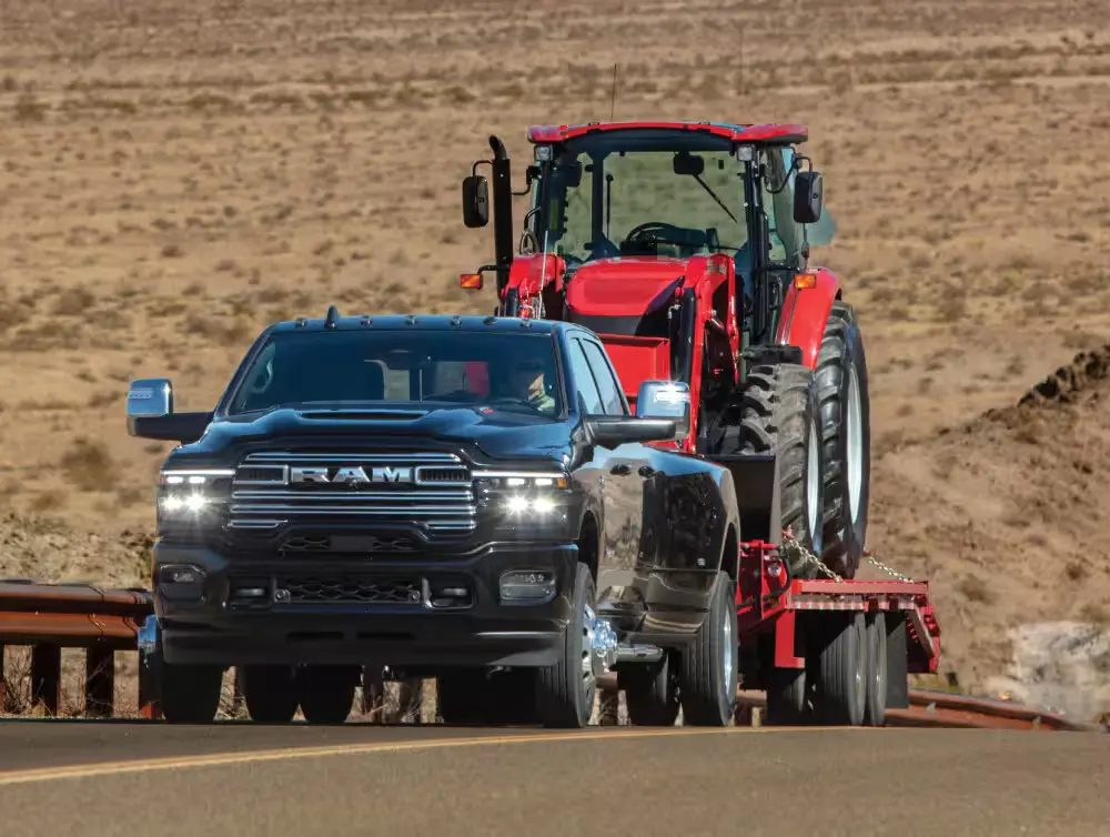 A ram 2500 pulling a trailer on the road.
