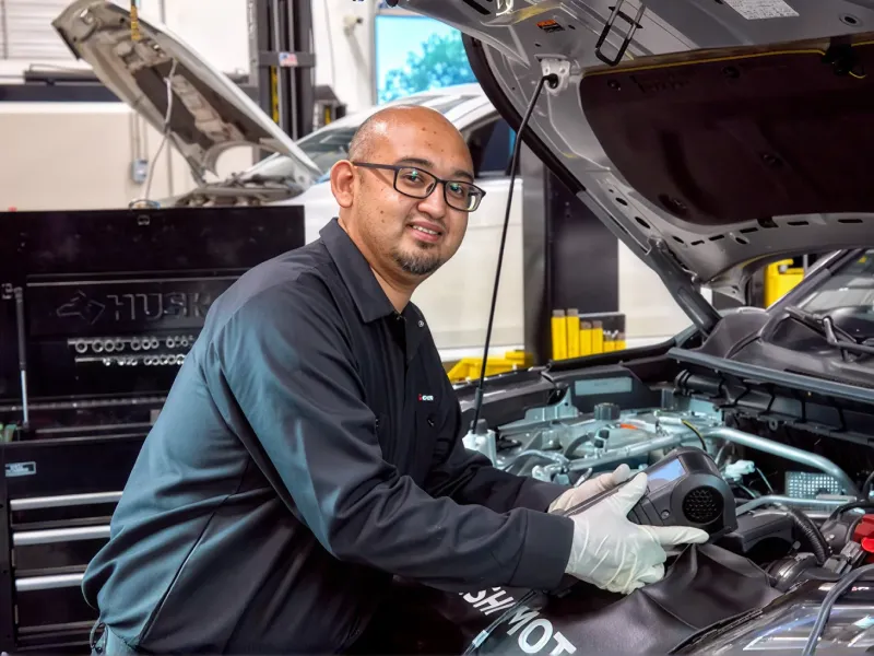Countryside Mitsubishi technician servicing a vehicle in the dealership service center