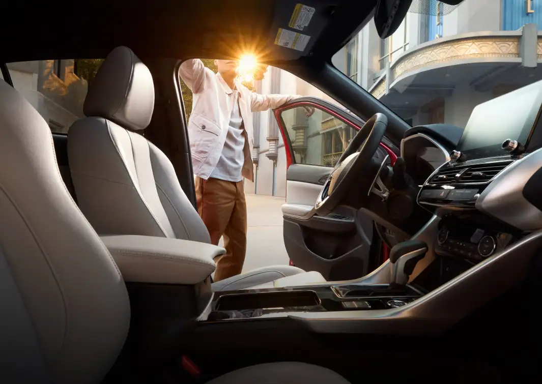 Modern Mitsubishi interior with a driver opening the front door