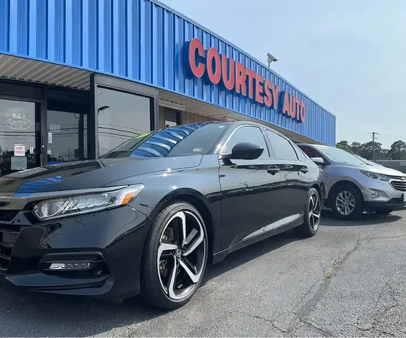Used cars parked outside Courtesy Auto Sales dealership in Chesapeake, VA