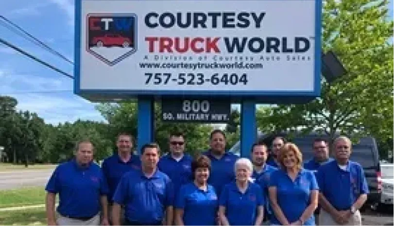 Courtesy Auto Sales team standing outside the Chesapeake dealership in its early years