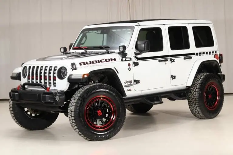 A 2020 Upgraded Rubicon, white paint, red accents, afterarket wheels and brush gaurd