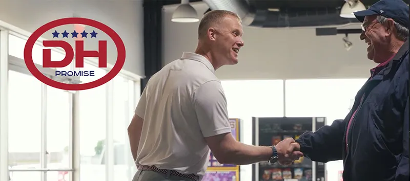 Salesperson shaking hands with a customer after a vehicle purchase at Dale Howard Auto Center