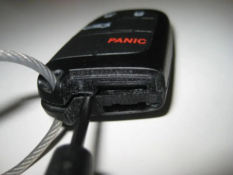 Key fob being pried apart.
