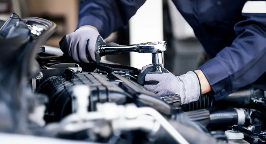 Technician using a torque wrench during engine repair at Dale Howard Auto Center in Iowa Falls, IA