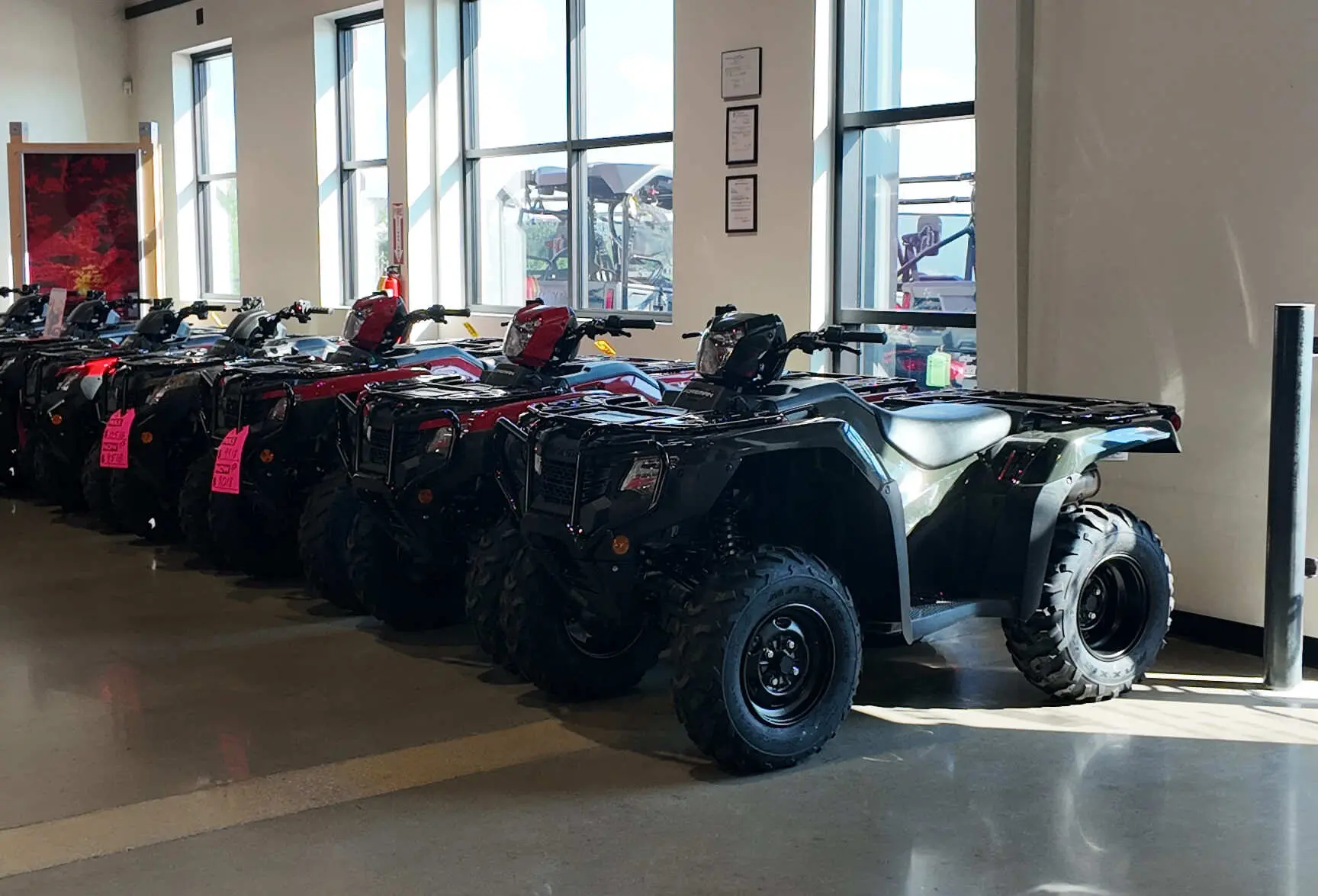 honda foretrax atvs lined up inside of dells honda powerhouse