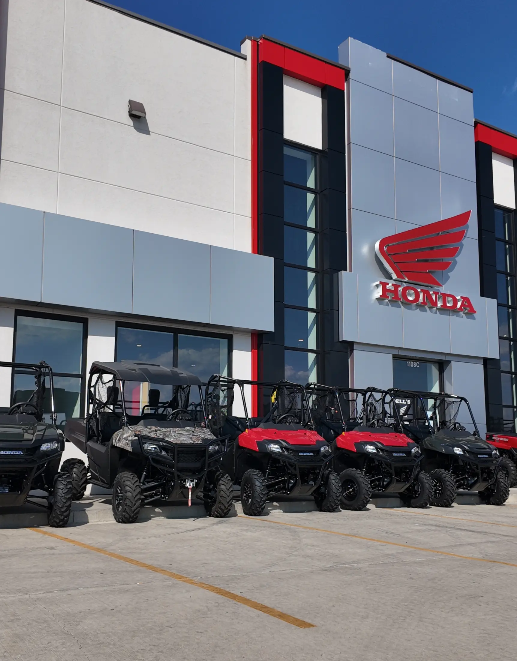 front of dells honda powerhouse with honda utvs lined up