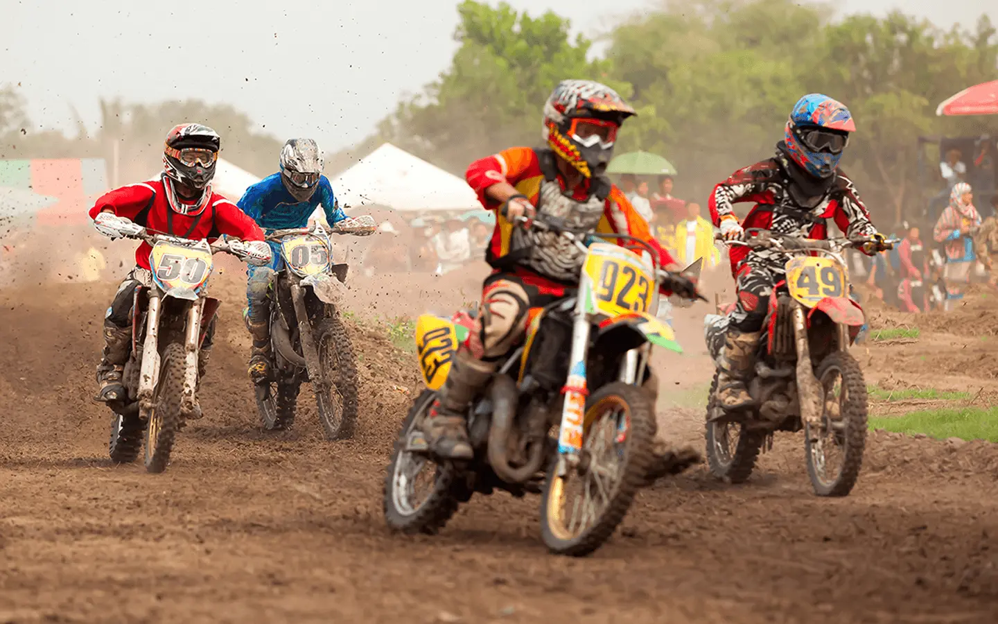 poeple racing dirt bikes on trail