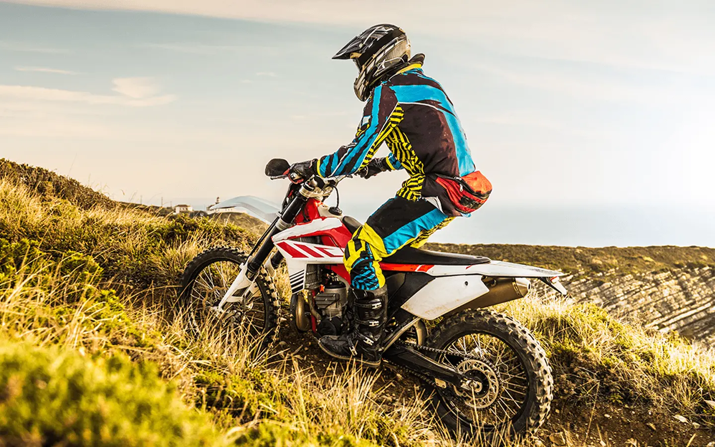 person riding dirt bike on a hilly trail