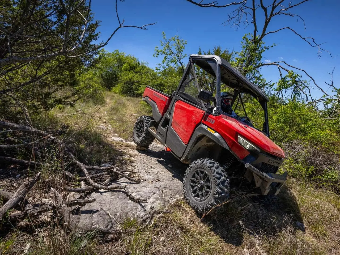 red honda pioneer driving off road