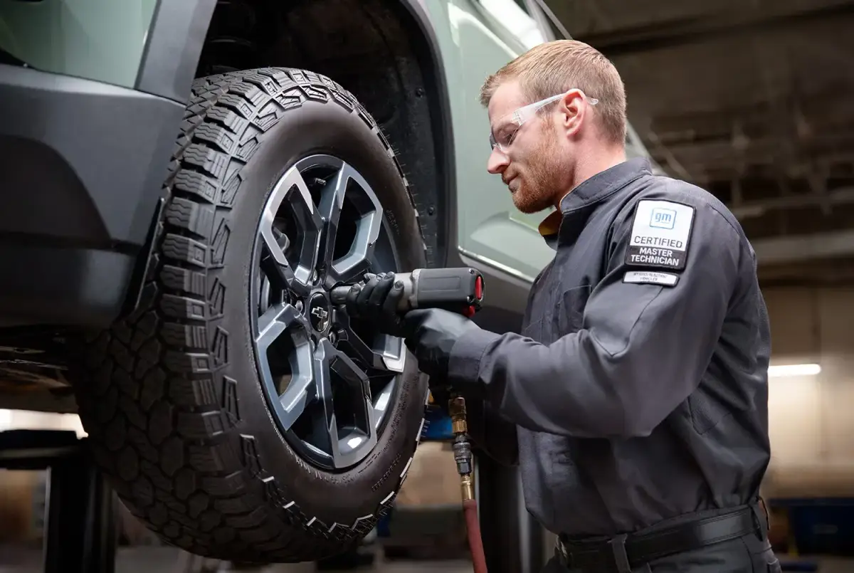 GM Certified technician servicing a tire on a Chevrolet vehicle