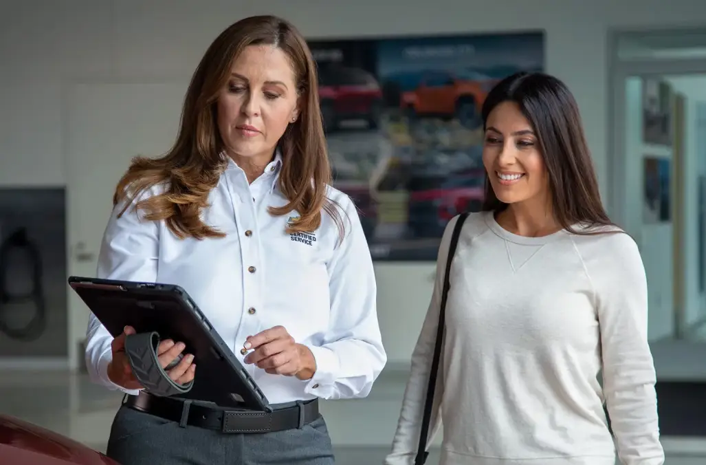 Chevrolet service advisor reviewing vehicle service details with a customer