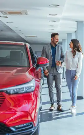 Car sales man discussing with lady about a new car