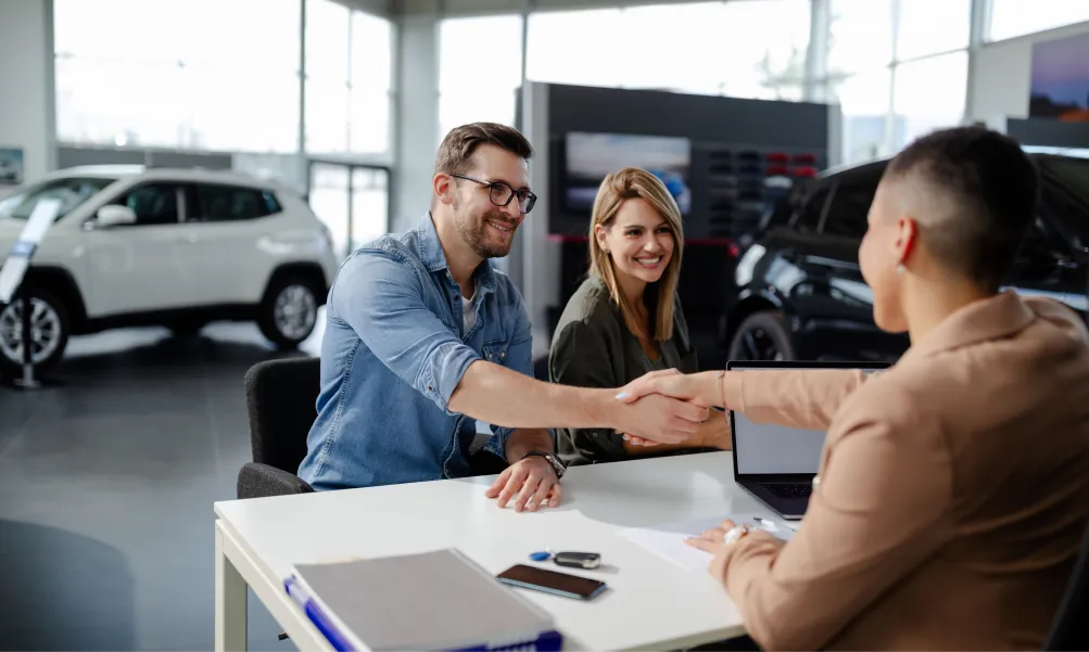 Emich Automotive team reviewing vehicle options with a customer