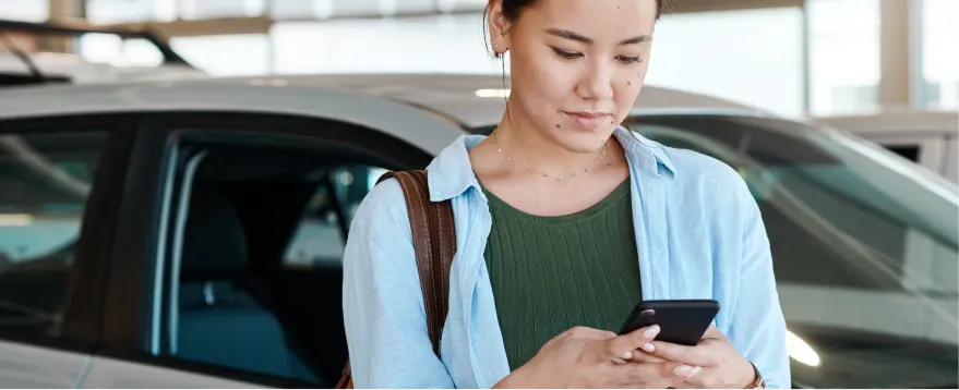 Customer using a phone to begin an online vehicle trade-in