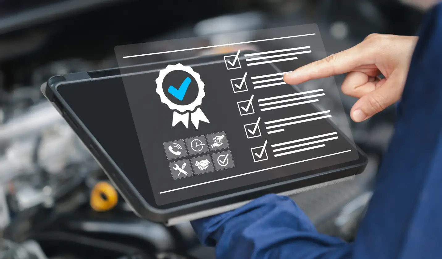 Technician reviewing a vehicle inspection checklist on a digital tablet in an auto service workshop.